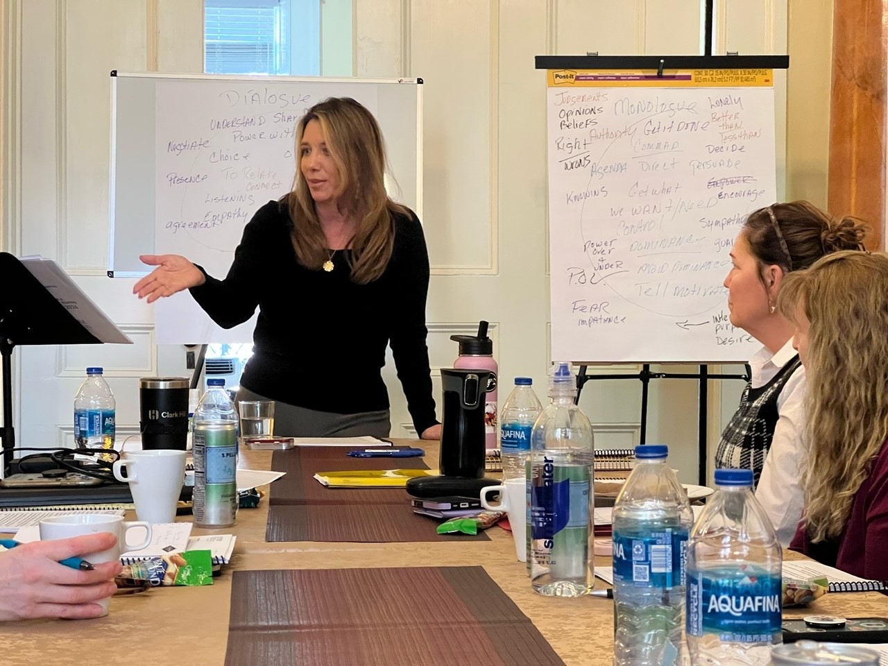 Alicia Marie leading a training session at a whiteboard